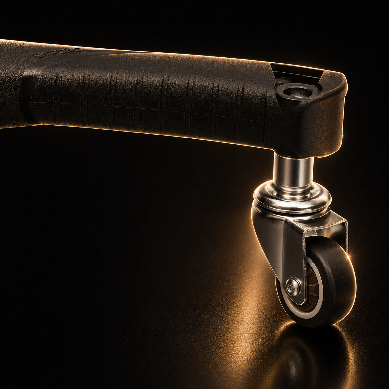 Close-up of a black caster wheel on a reflective surface with a dark background
